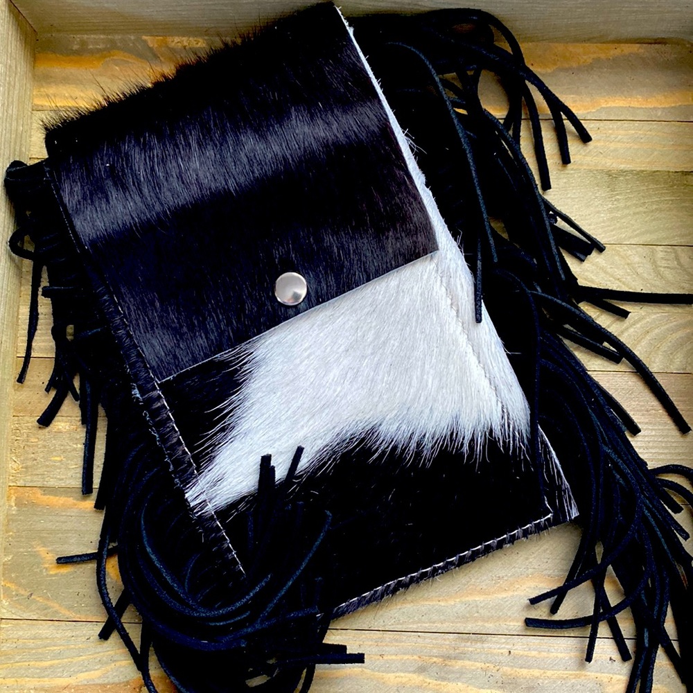 Saddle pouch for the back cinch. Black and white hair on hide.